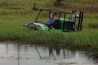 Hydratrek driving over a floating weed mass